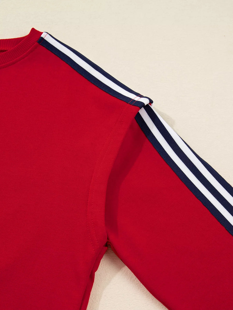 Red sweatshirt with navy and white varsity stripe detail on the sleeves.
