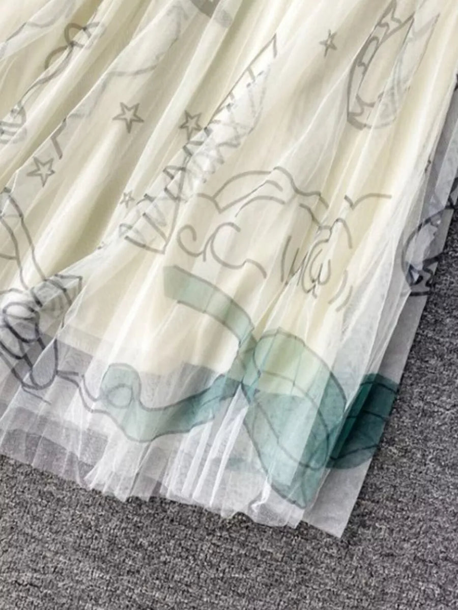Off-white tulle skirt with whimsical abstract sunburst print and pleated hem.