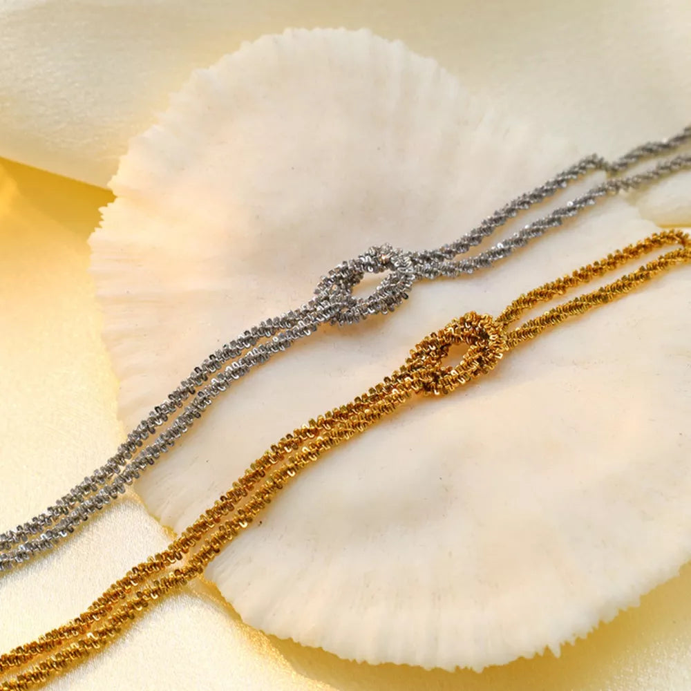 silver bracelet featuring twisted chain and twisted