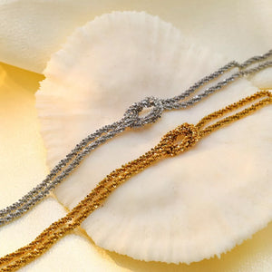 silver bracelet featuring twisted chain and twisted