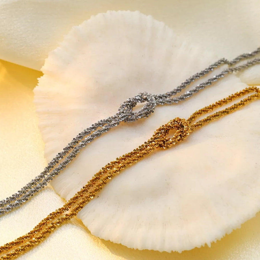 silver bracelet featuring twisted chain and twisted