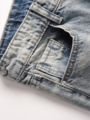 Distressed wash bootcut jeans with raw hem detail in medium blue denim.