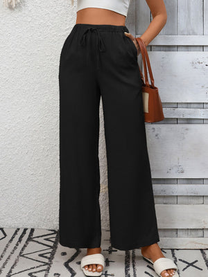 Black high-waist wide-leg pants with drawstring and pockets.
