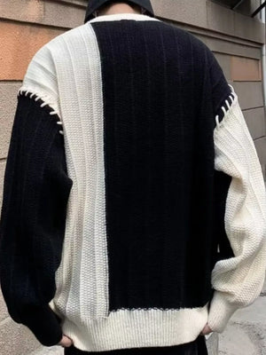 Oversized black and white color block sweater with contrast stitching detail.