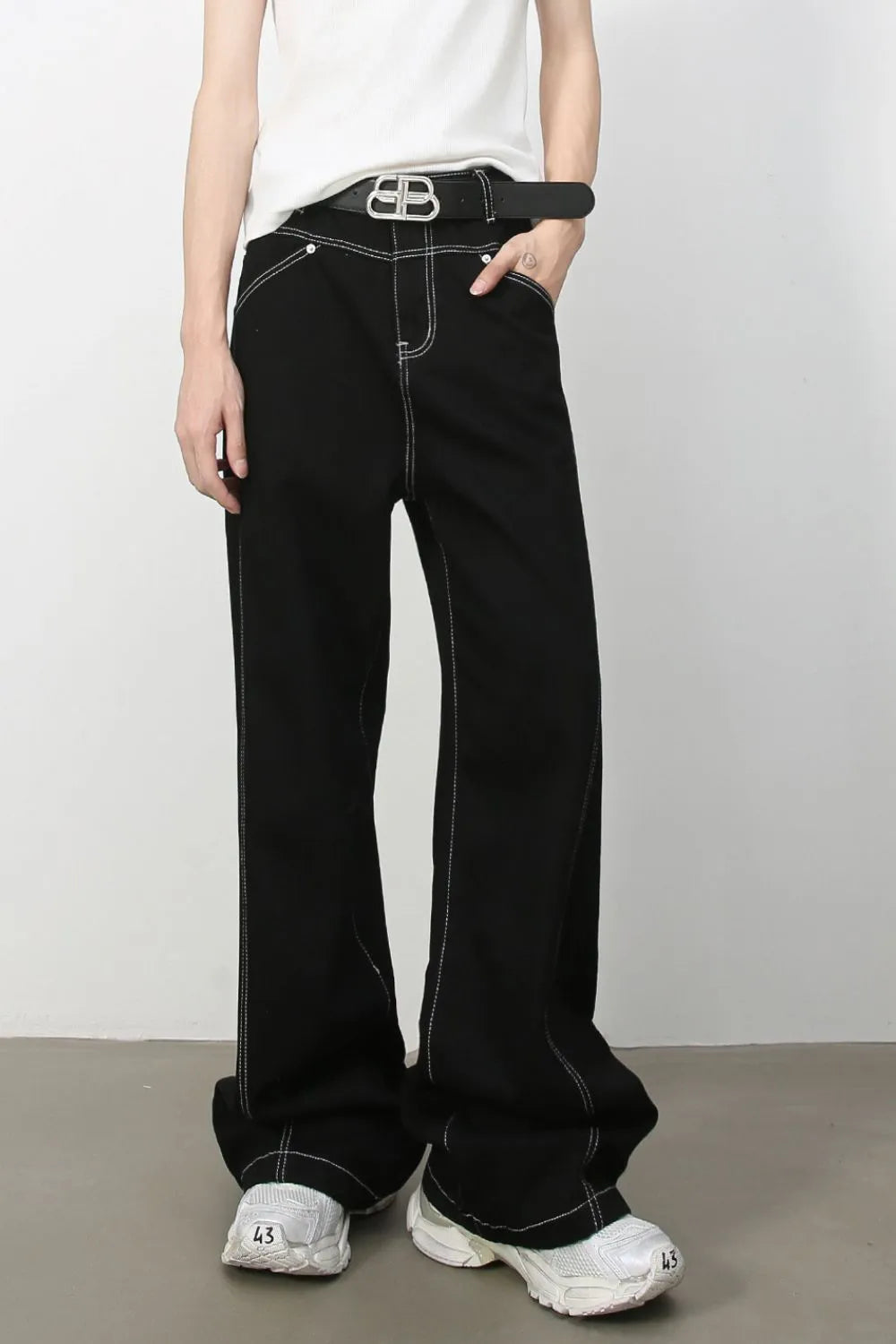 Black relaxed fit denim jeans with contrast stitching and a wide leg.