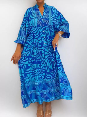 Vibrant abstract print midi dress in sky blue with a collared neckline and button front.