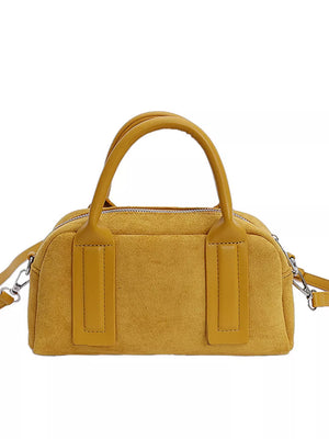 Chic yellow suede crossbody bag with handles and silver hardware.