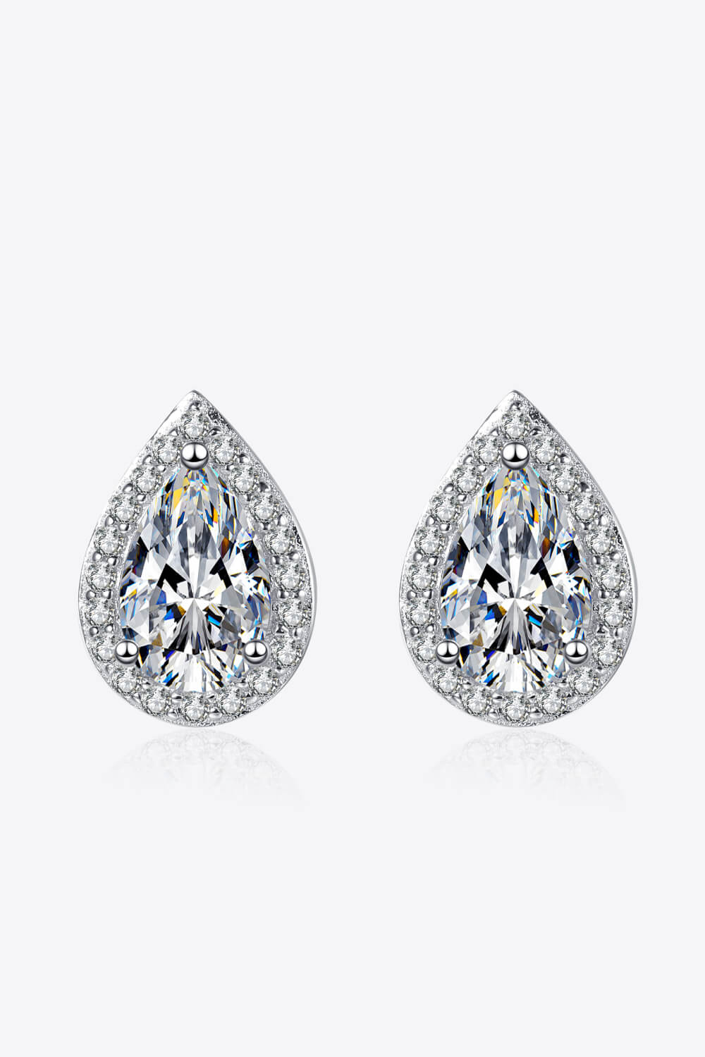 Silver teardrop halo earrings with clear pavé accents and a large center stone.