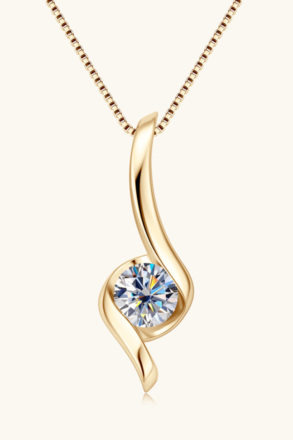 Gold moissanite pendant necklace with a swirling design and a round-cut stone.