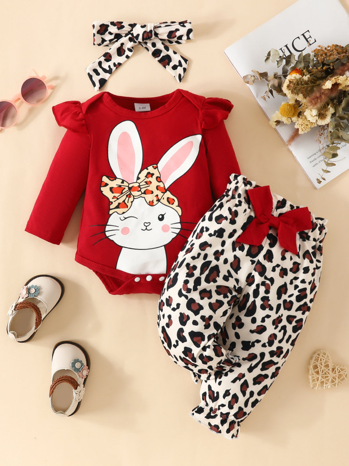 Red bunny bodysuit with leopard print pants and bow headband.