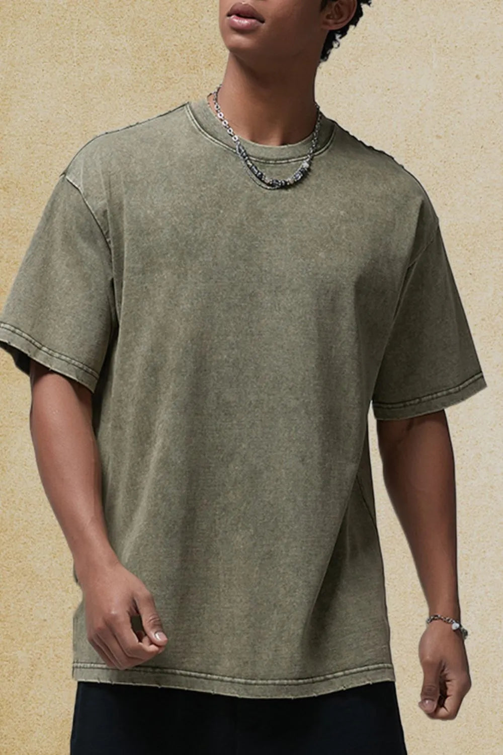 Sage green washed half-sleeve round neck t-shirt with raw hem detail.