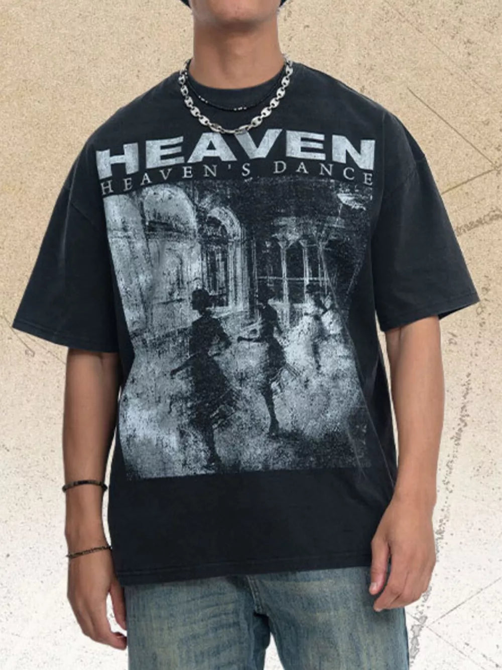 Black oversized graphic tee with crew neck and "Heaven's Dance" print.