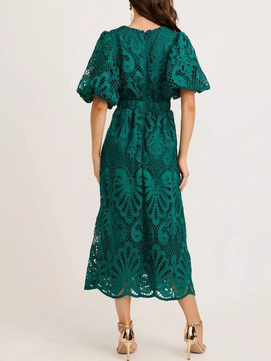 Green lace midi dress with puff sleeves and cinched waist, featuring intricate openwork.