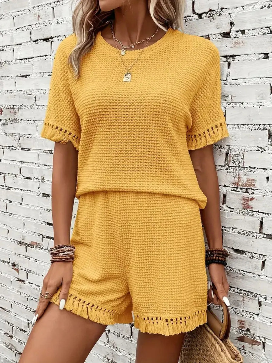 Yellow textured knit set with fringe detail on short sleeves and hem.