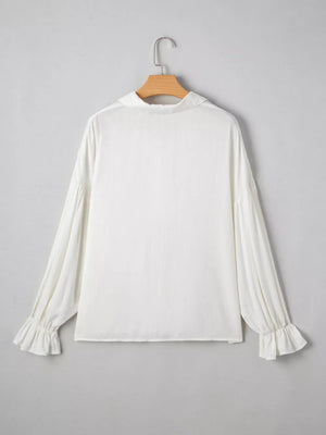 White long sleeve blouse with ruffled cuffs and collar