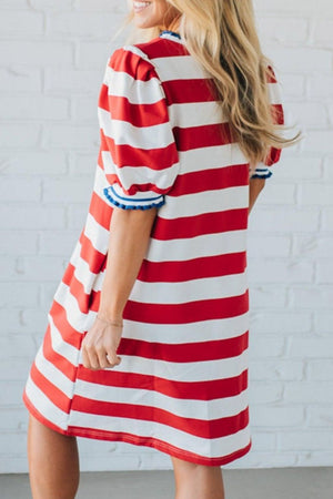 Red and white striped cotton mini dress with puff sleeves and blue trim.