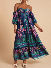 Maxi dress with cold shoulders, smocked bodice, and tropical palm print.