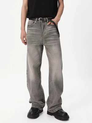 Men's vintage wash wide leg jeans in gray cotton, styled with a black belt and shoes.