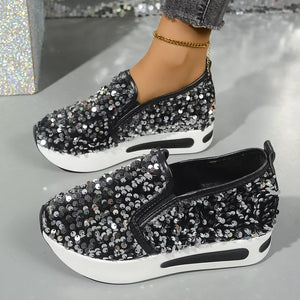 Black sequin slip-on shoes with white platform sole.