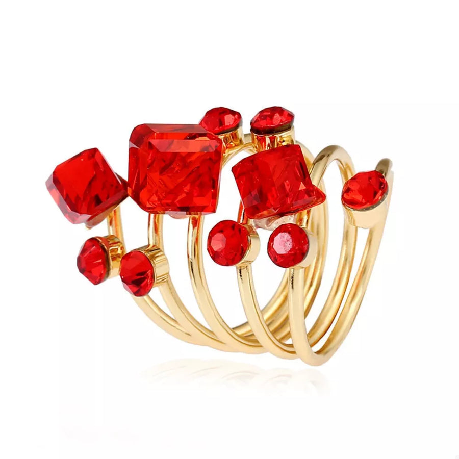 Gold-plated ring with multiple layers and red crystals in square and round cuts.