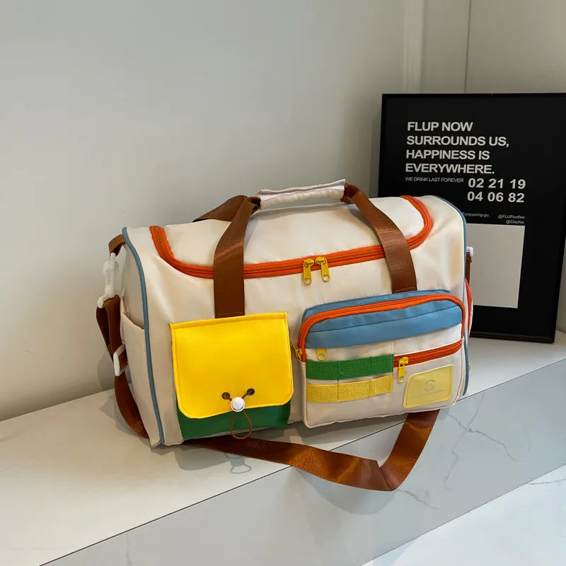 Beige duffel bag with bright colorblock pockets and brown straps