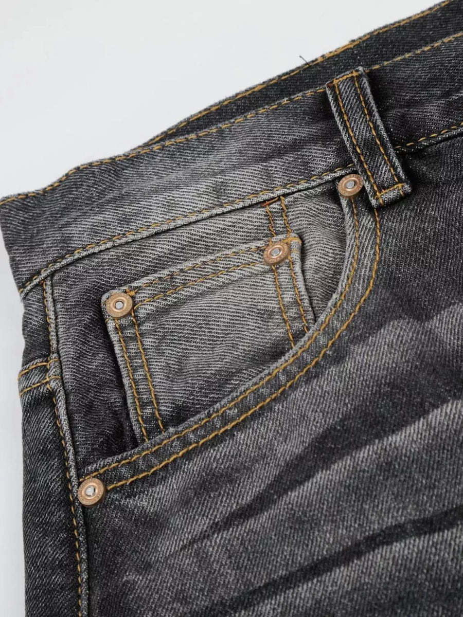 Men's black distressed wide-leg jeans with contrast stitching and pocket detail.