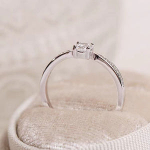 Sterling silver ring with a solitaire moissanite and pave band.
