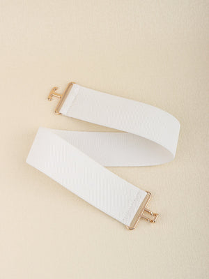 White elastic belt with sculpted gold buckle and textured band
