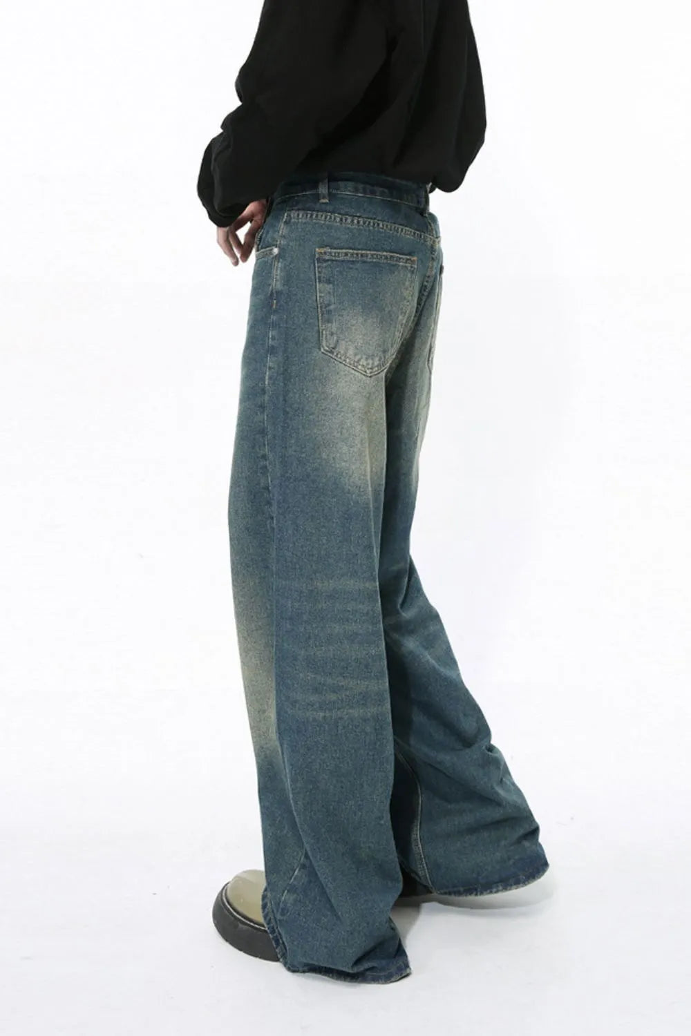 Faded wash wide-leg jeans in medium blue denim with a relaxed fit.