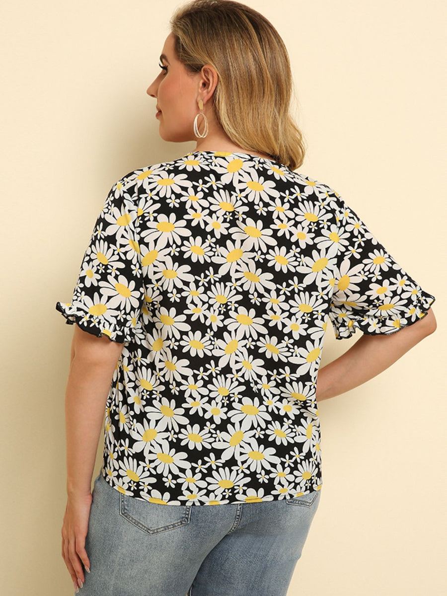 Daisy print blouse with ruffle sleeves and knot detail, floral pattern on black.