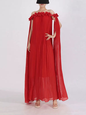 Red off-shoulder maxi dress with cape sleeves and floral applique detail.