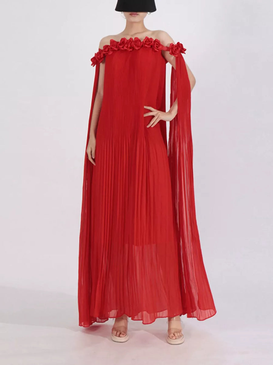 Red off-shoulder maxi dress with cape sleeves and floral applique detail.