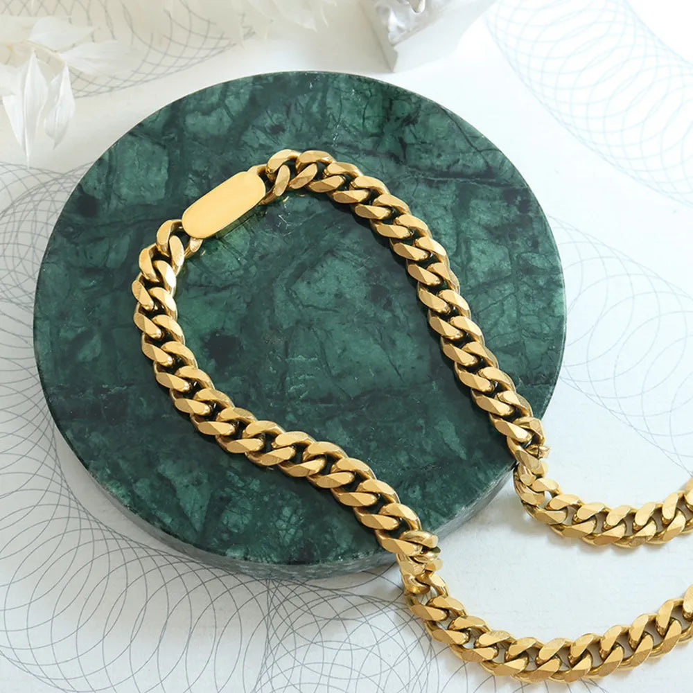 Gold Cuban link chain necklace with a bold, chunky design and a smooth clasp detail.