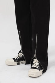 Dark denim jeans with relaxed fit and zip-hem detail.