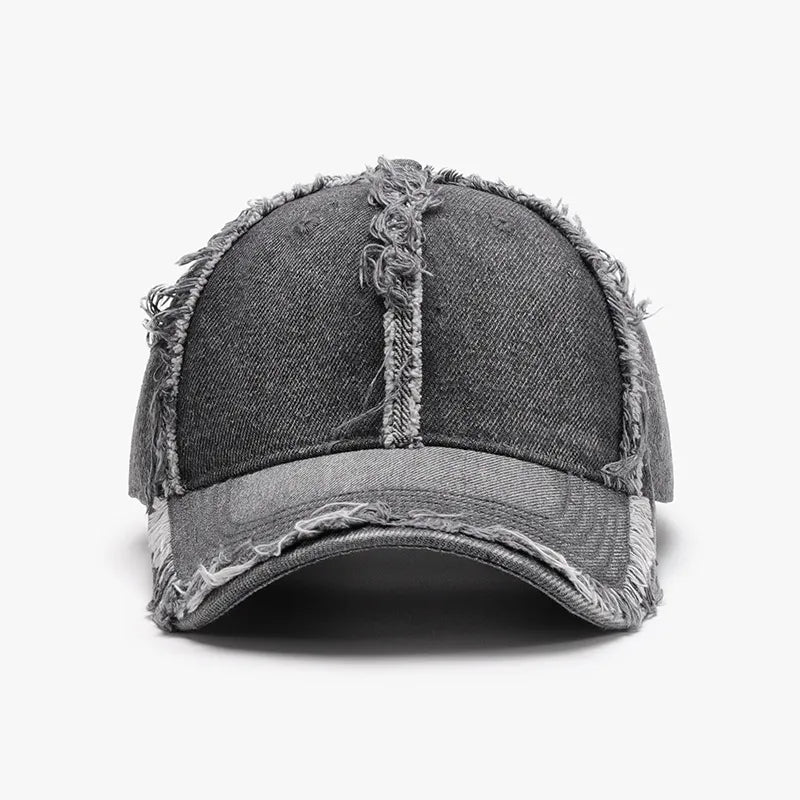 Distressed gray denim baseball cap with frayed edges and visible stitching details.