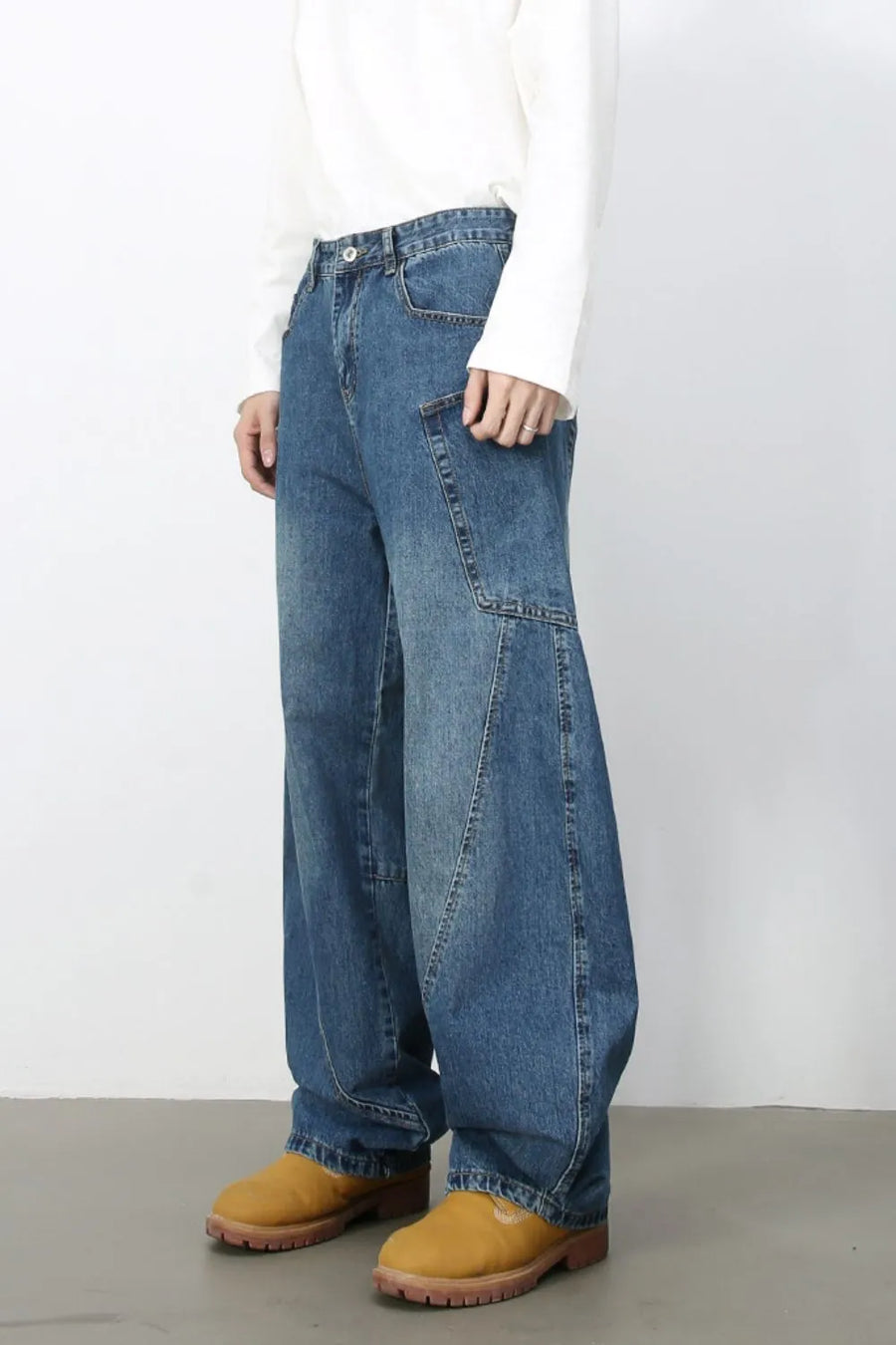 Sculpted denim balloon trousers in medium wash with unique paneling and wide leg.