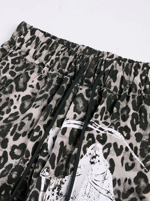Leopard print cotton sweatpants with drawstring waist and graphic detail.