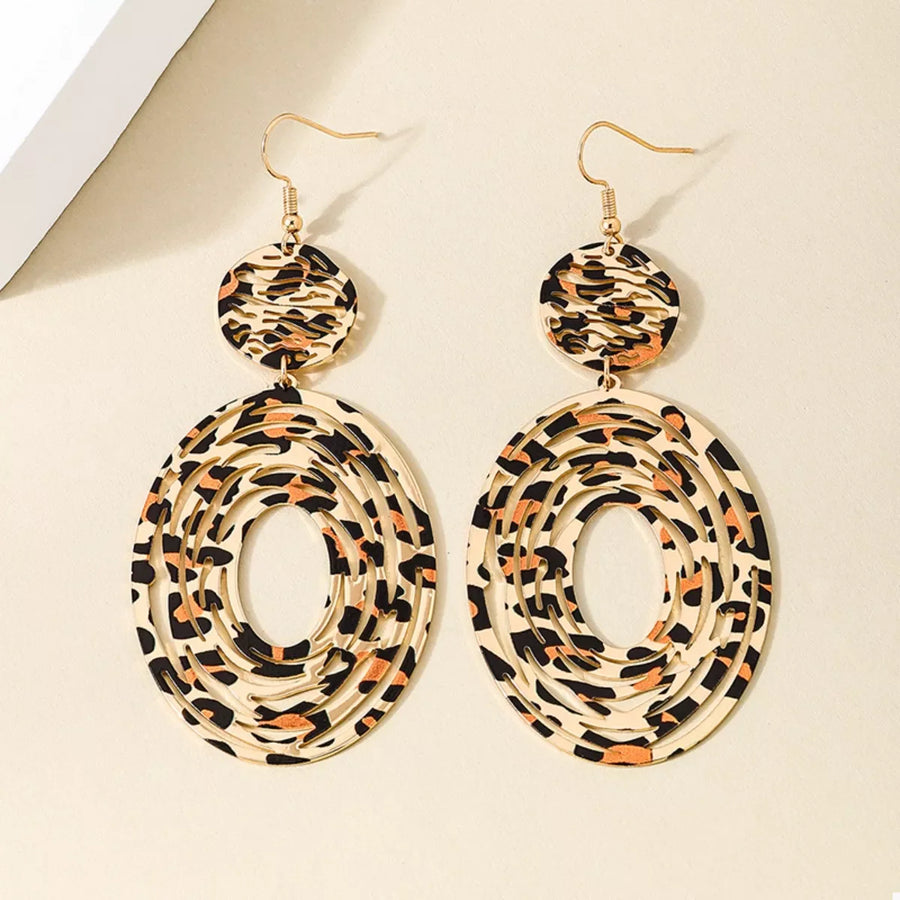 Bold dangle earrings in 18K gold with leopard print pattern.