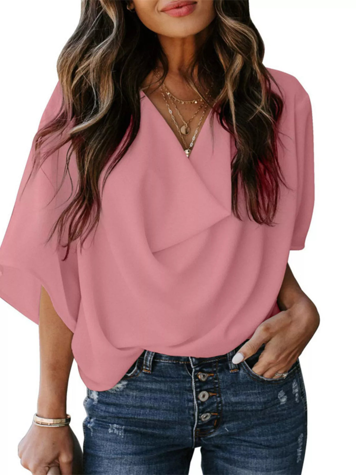 Pink flowy half sleeve blouse with V-neck and draped front, styled with jeans.