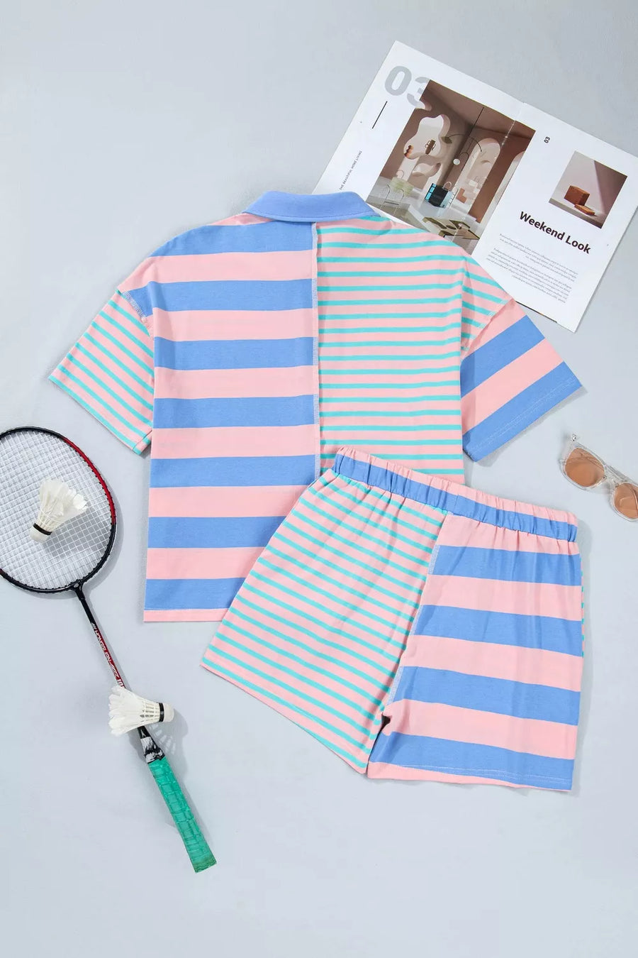 Striped polo shirt and shorts set in pink, blue, and teal.
