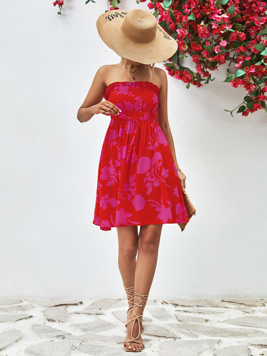Smocked bandeau floral mini dress in red with pink flowers, A-line cut, strapless, cinched waist.