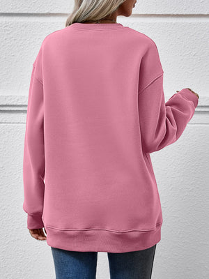 Blush Pink crewneck sweatshirt with ribbed cuffs and hem, relaxed fit.