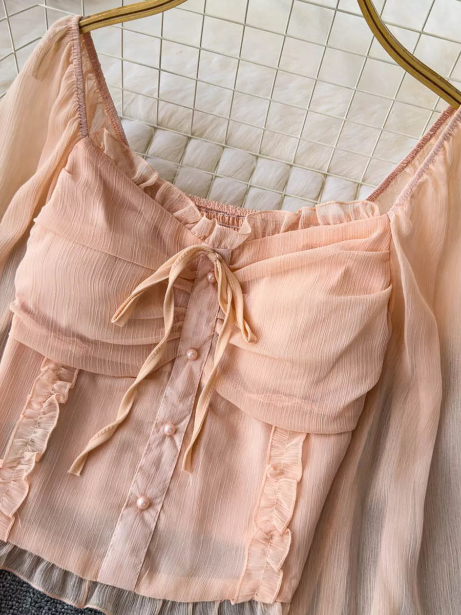 Peach ruffled sleeve maternity blouse with bow and pearl buttons