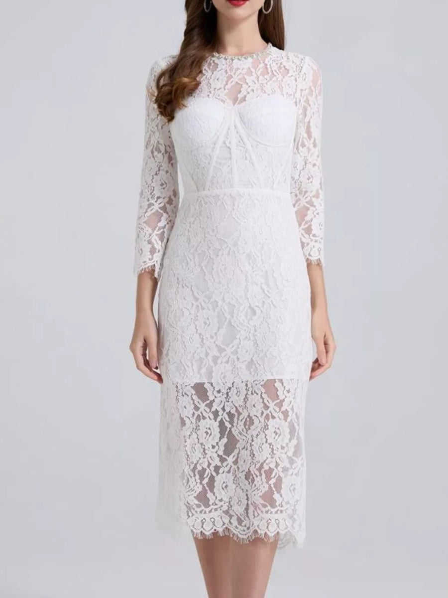 White lace midi dress with sheer sleeves and a sweetheart neckline detail.