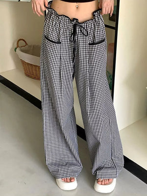 High-waisted wide-leg gingham pants with drawstring and black trim.