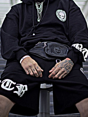 Black hoodie with skull patch and white graphic shorts