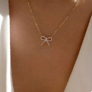 Gold bowknot pendant necklace with clear stones on a delicate chain
