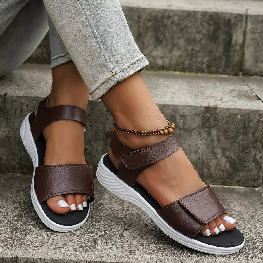 Brown adjustable platform sandals with open toe and chunky sole.