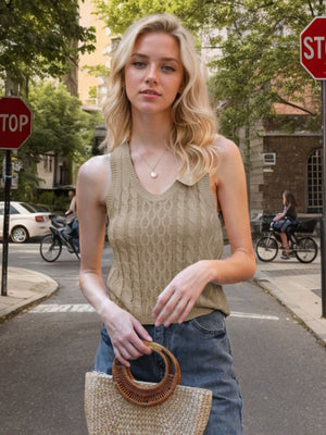 Beige cable knit tank top with a collared neckline and V-neck detail.