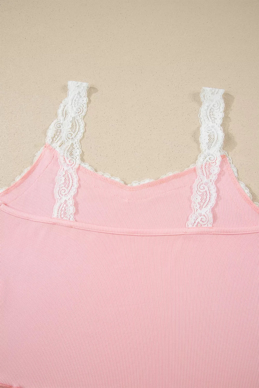 Pink ribbed cami pajama top with white lace trim straps and neckline.